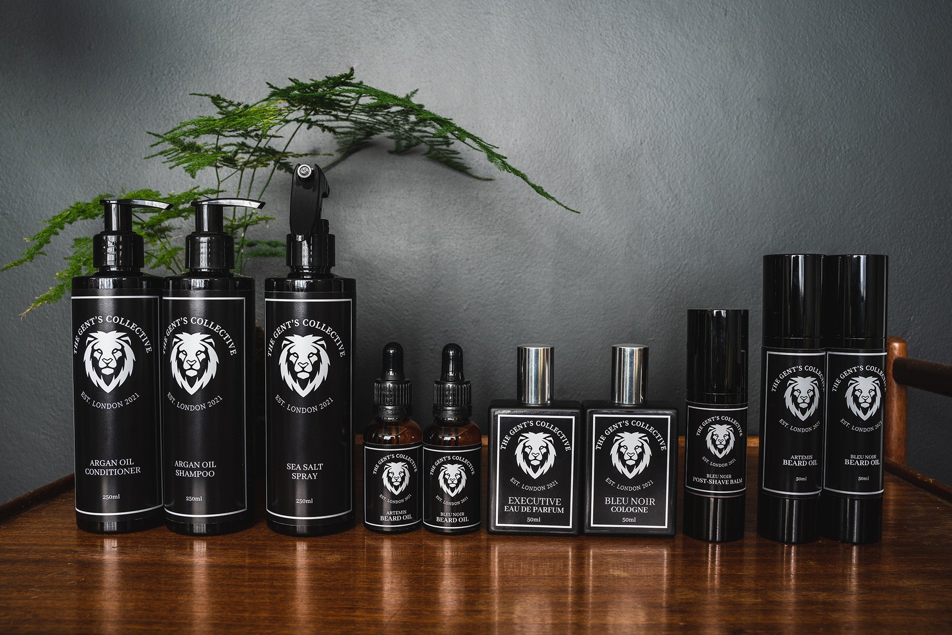 Collection of The Gent's Collective's sustainable product line: Bleu Noir and Executive Colognes 50ml, Bleu Noir and Artemis Beard Oils 30ml/50ml, Bleu Noir Post Shave Balm, Argan Oil Shampoo and Conditioner, Sea Salt Spray